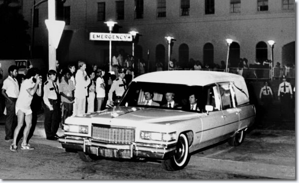 People wait near the emergency entrance of Baptist Memorial Hospital as the hearse carrying the body of Elvis Presley leaves the hospital Aug. 16, 1977