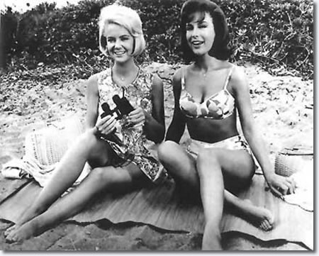 Shelly Fabares and Barbara Eden on a beach blanket together in 1964.