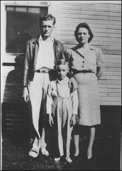 Elvis and his parents in front of their home.